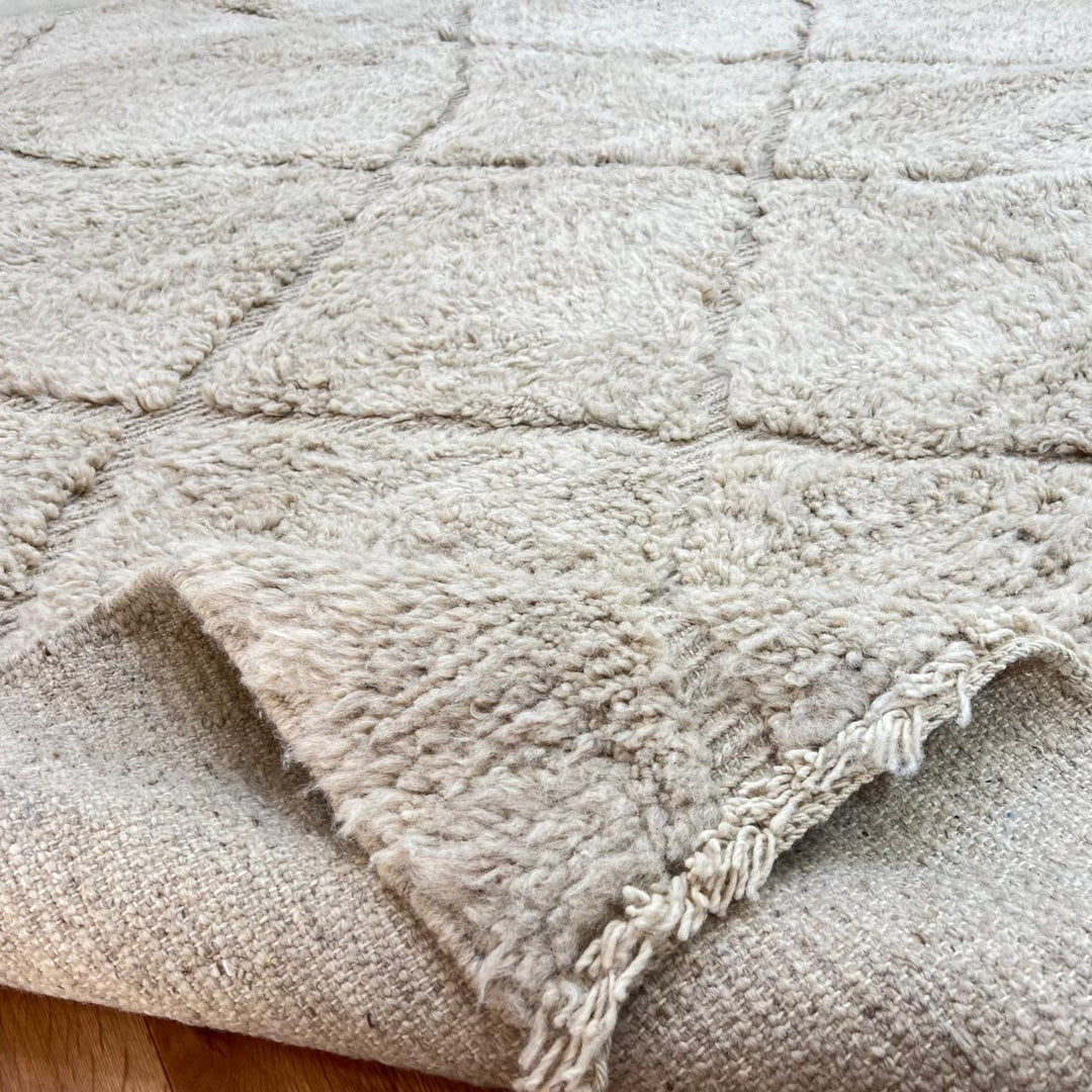 Cream Moroccan wool rug with diamond Berber pattern and plush texture
