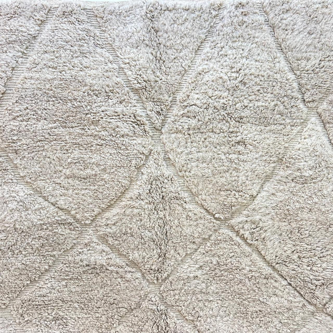 Cream Moroccan wool rug with diamond Berber pattern and plush texture