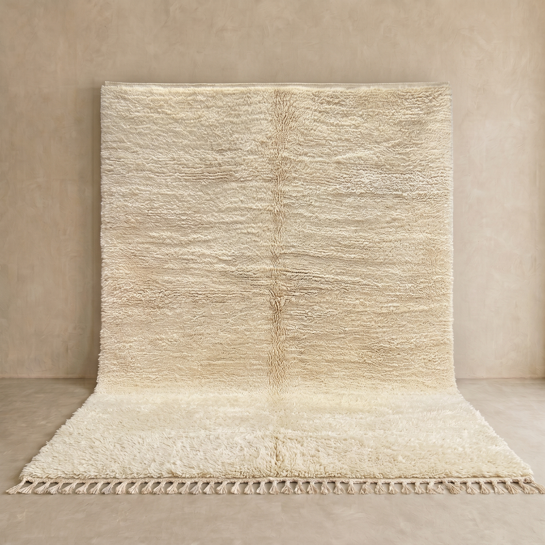 Cream handmade Moroccan wool rug with soft plush texture and fringed edges
