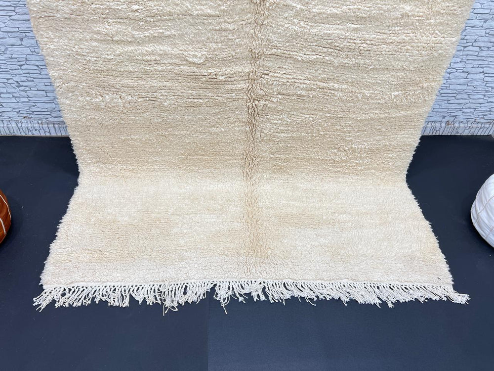 Cream handmade Moroccan wool rug with soft plush texture and fringed edges