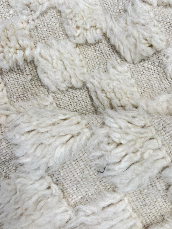 Cream textured Moroccan wool rug with raised dot design