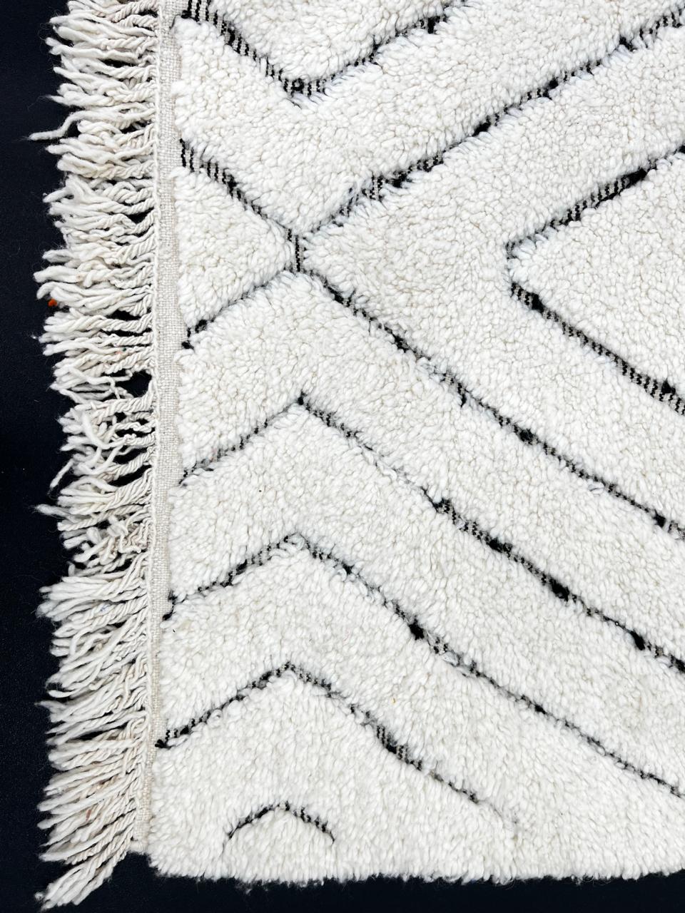 Handmade cream white Moroccan wool rug with black diamond lines and plush wool texture
