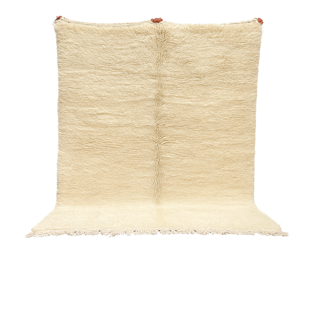 Cream handmade Moroccan wool rug with soft plush texture and fringed edges
