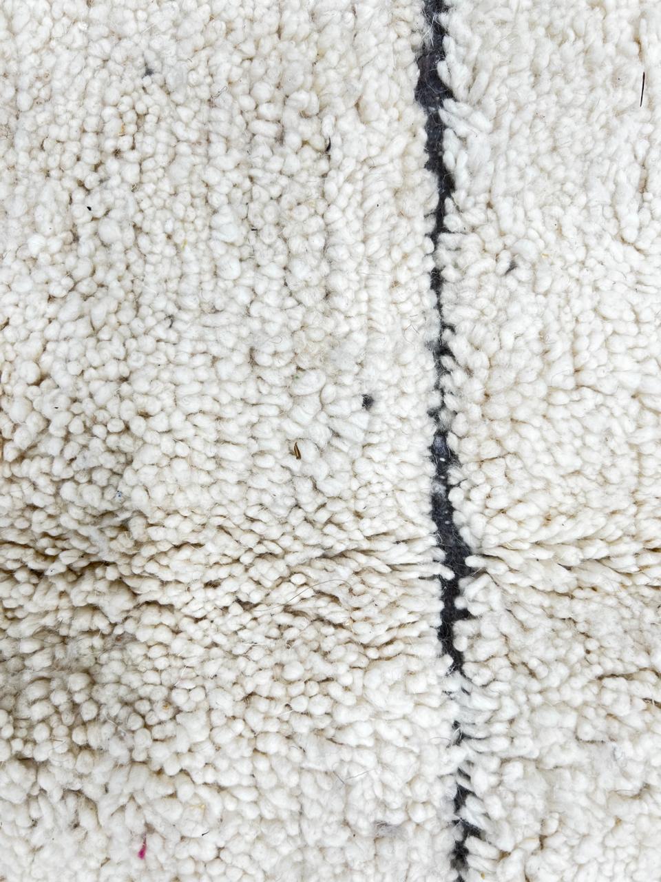 Cream Moroccan wool rug with charcoal gray geometric border and linear Berber pattern