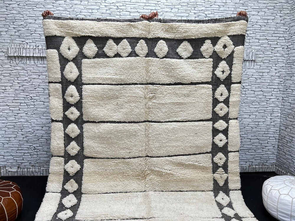 Cream Moroccan wool rug with charcoal gray geometric border and linear Berber pattern