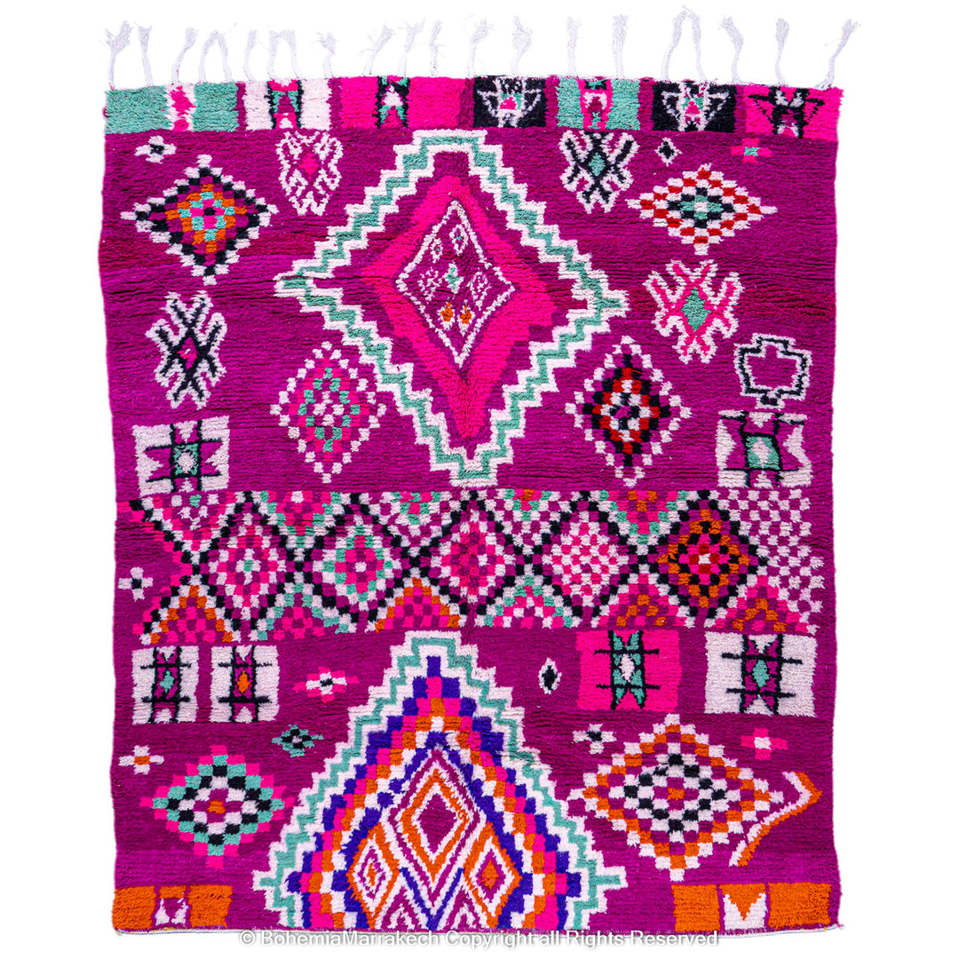 Pink Azilal Moroccan rug with geometric motifs, handcrafted with vibrant colors including turquoise and orange, made from natural wool.