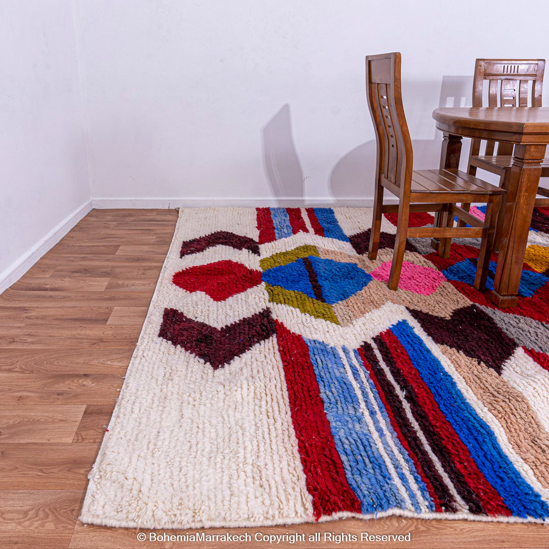 Colorful geometric Azilal rug made of natural wool, featuring vibrant diamond patterns, suitable for Moroccan bohemian decor.