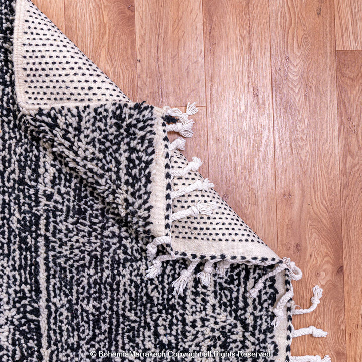 Grey Moroccan wool rug with marbled pattern and fringe, handwoven by Berber artisans, perfect for modern interiors, 8x10 size.