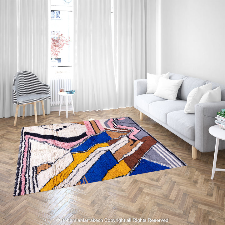 Colorful Abstract Moroccan Berber Wool Rug with zigzag patterns in blue, yellow, and pink, displayed in a modern living room setting.