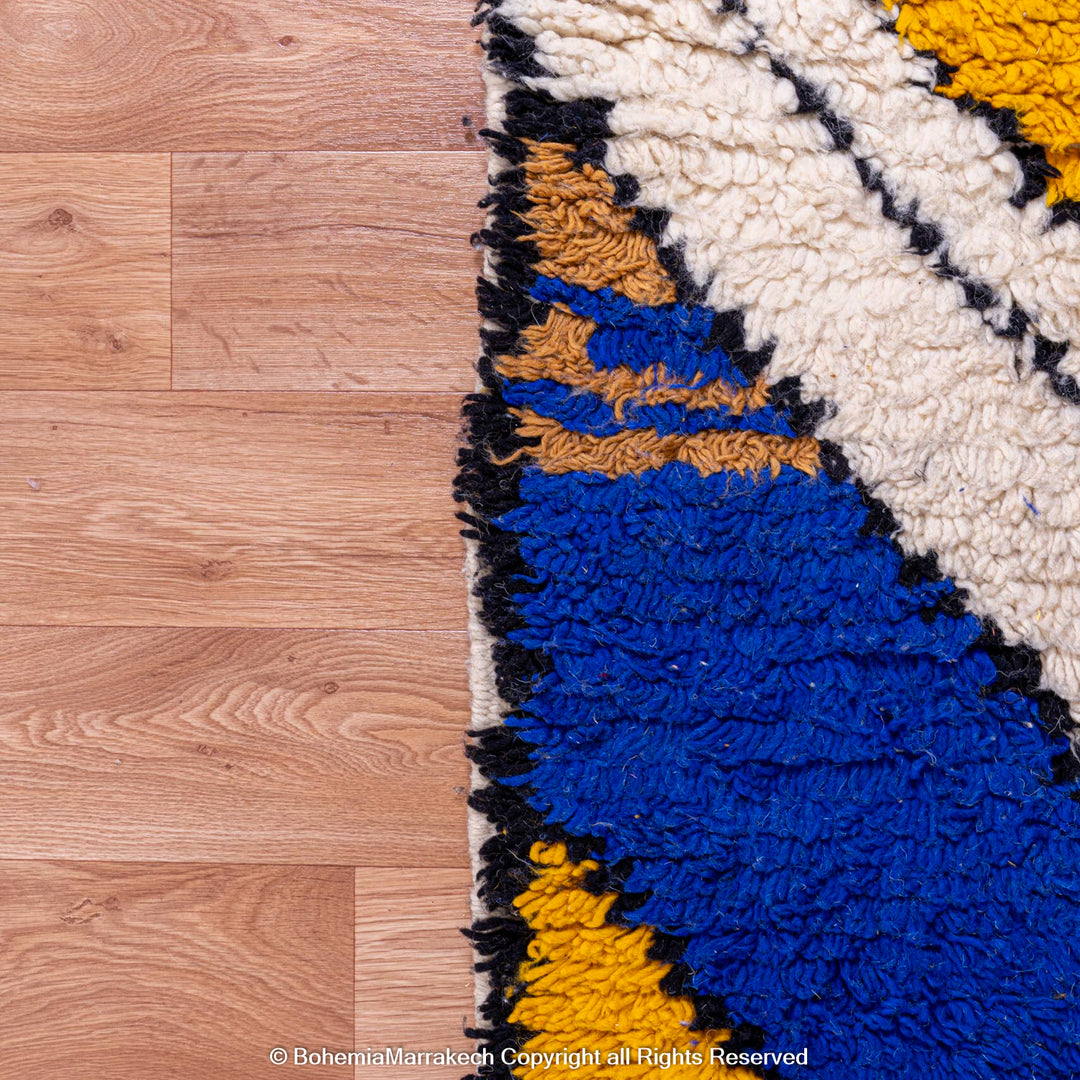 Colorful Abstract Moroccan Berber Rug with Blue and Mustard Zigzags on Wooden Floor