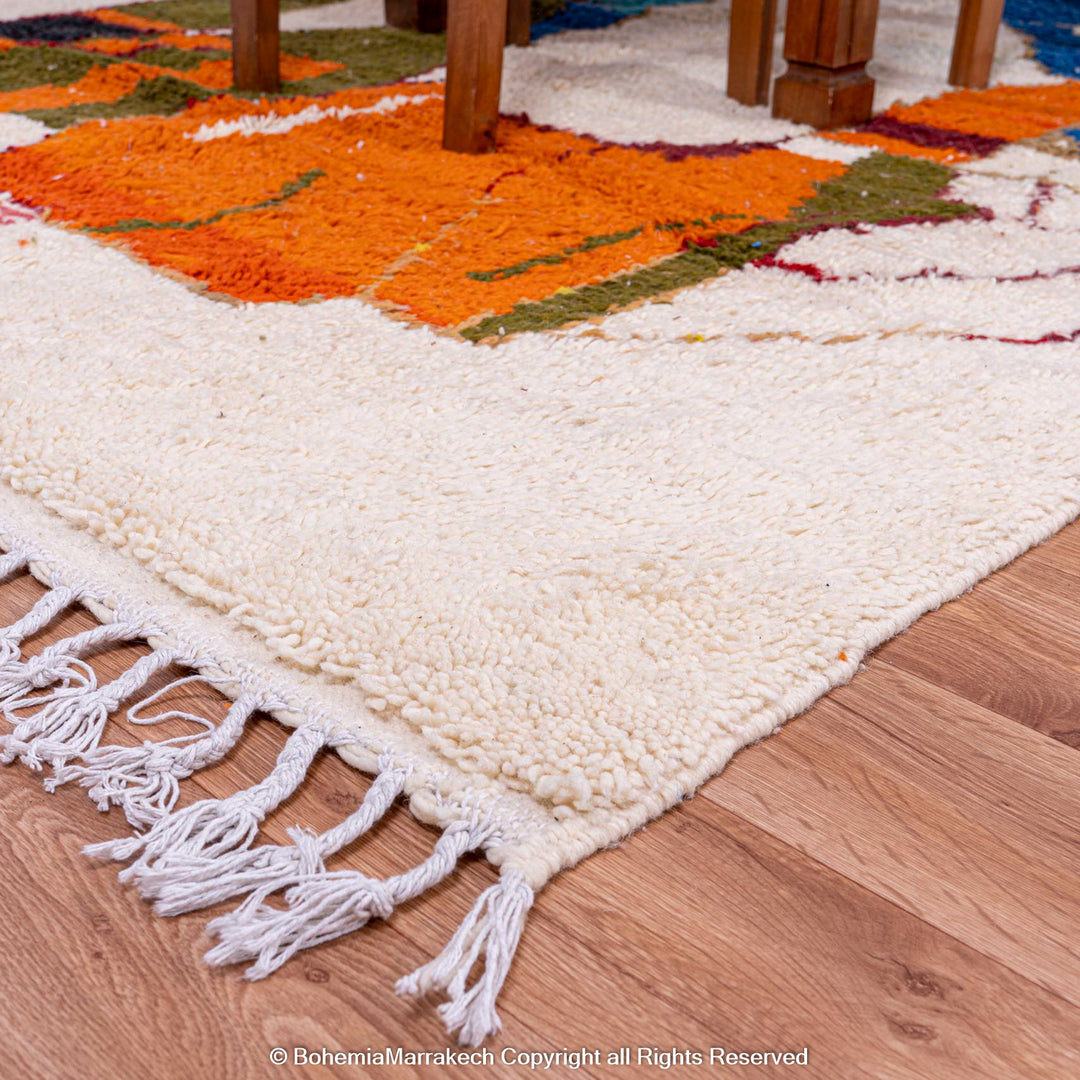 Abstract camel design on colorful Moroccan rug by Berber artisans, handwoven wool, featuring bold desert colors.
