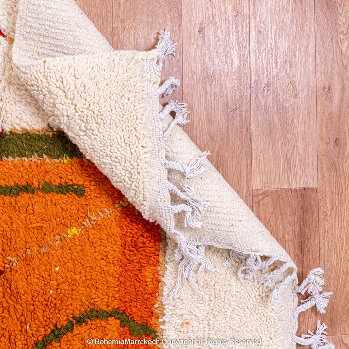 Colorful Moroccan rug with abstract camel design, featuring earthy tones, handwoven with natural wool by Berber artisans. Moroccan rug.