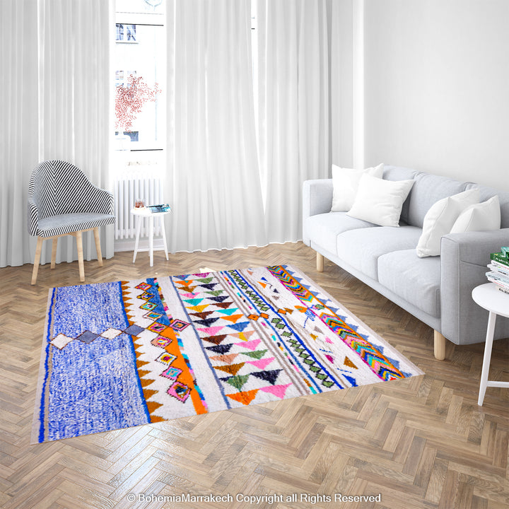 Bright colorful Moroccan rug with tribal motifs, handmade by Berber women, featuring geometric patterns on white wool, in living room.