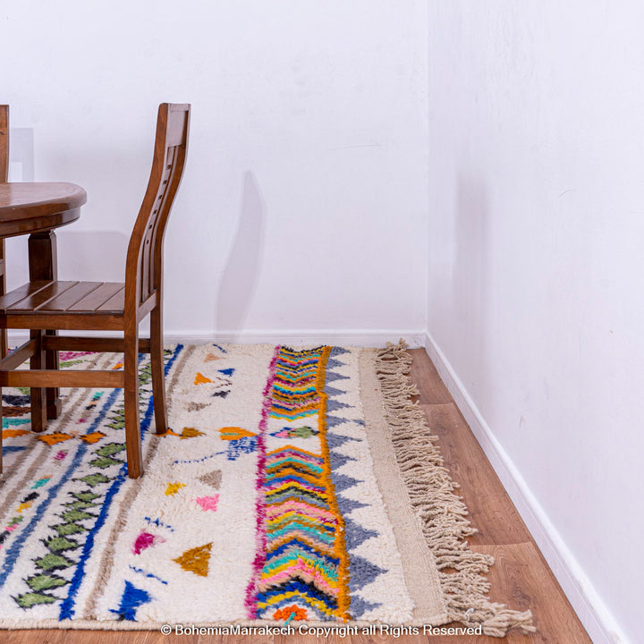 Colorful Moroccan rug with tribal motifs and geometric shapes, perfect for adding style to any home, handmade by Berber women.