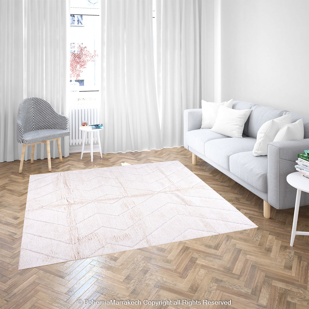 White Moroccan rug with subtle zigzag pattern in a modern living room setting, 8x10 handwoven Moroccan wool rug.