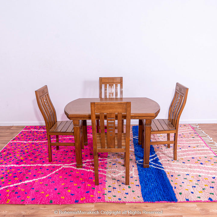 Pink and blue Moroccan rug with multicolor specks and geometric white lines