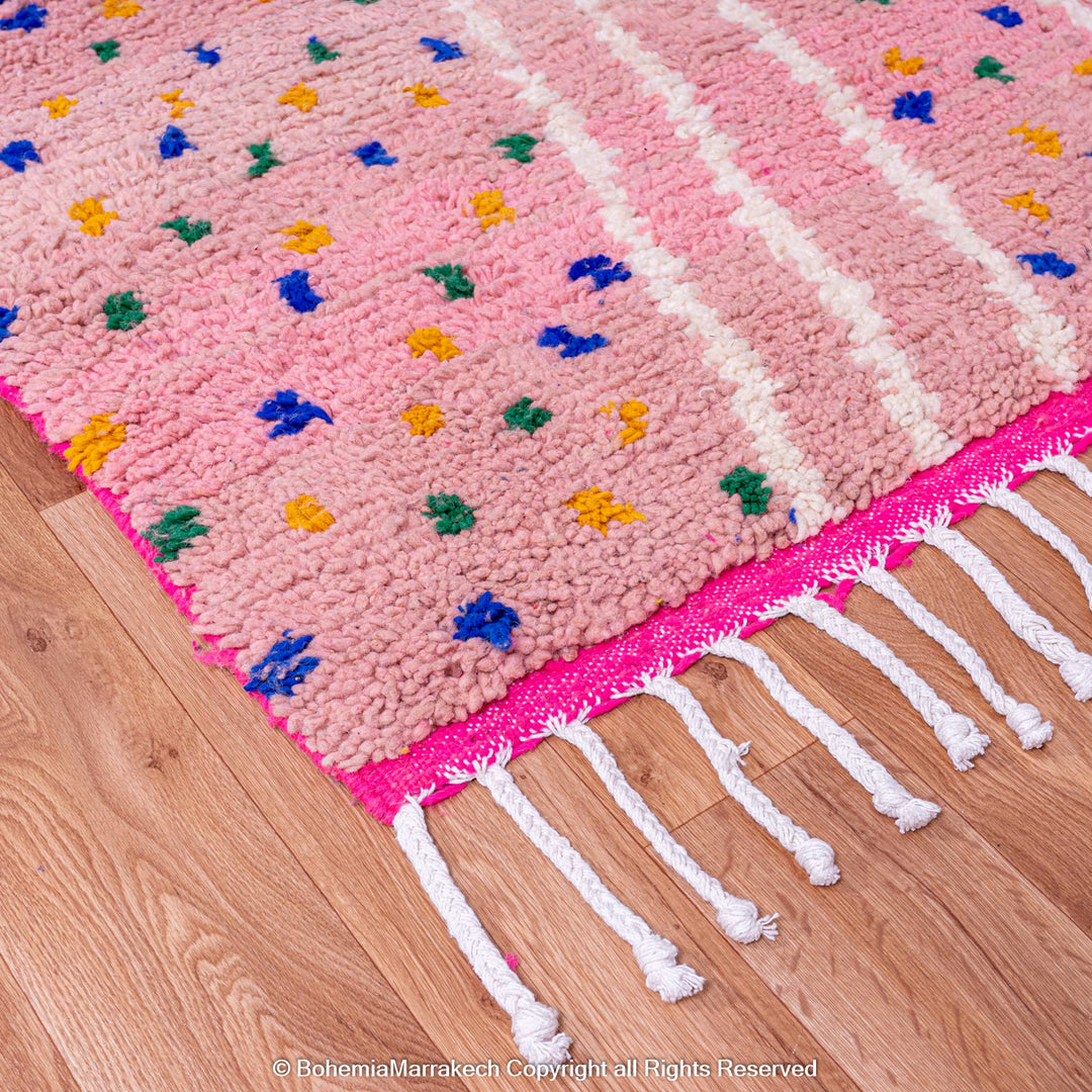 Pink and blue Moroccan rug with multicolor specks and geometric white lines