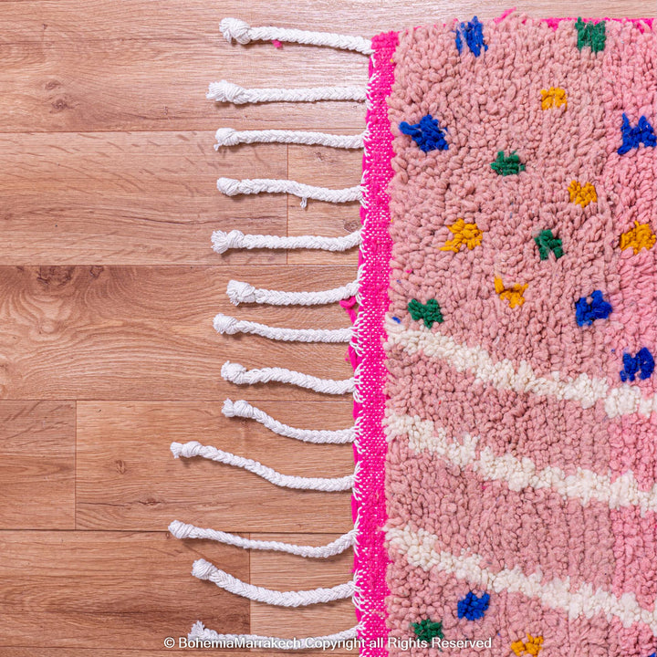Pink and blue Moroccan rug with multicolor specks and geometric white lines