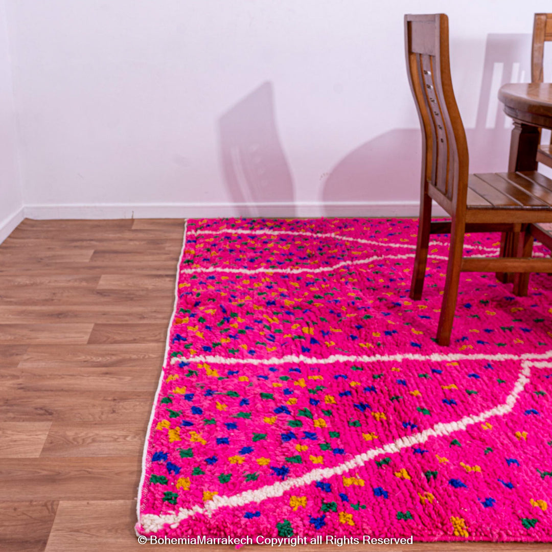 Pink and blue Moroccan rug with multicolor specks and geometric white lines