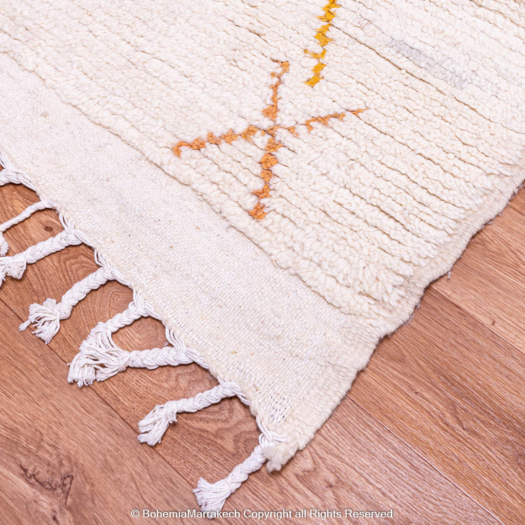 Minimal handmade Moroccan rug with diamond Berber motifs on white wool