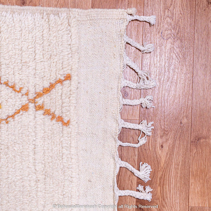 Minimal handmade Moroccan rug with diamond Berber motifs on white wool