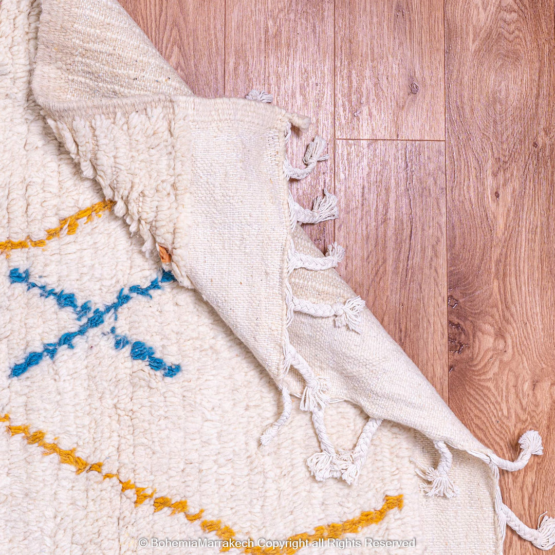 Minimal handmade Moroccan rug with diamond Berber motifs on white wool