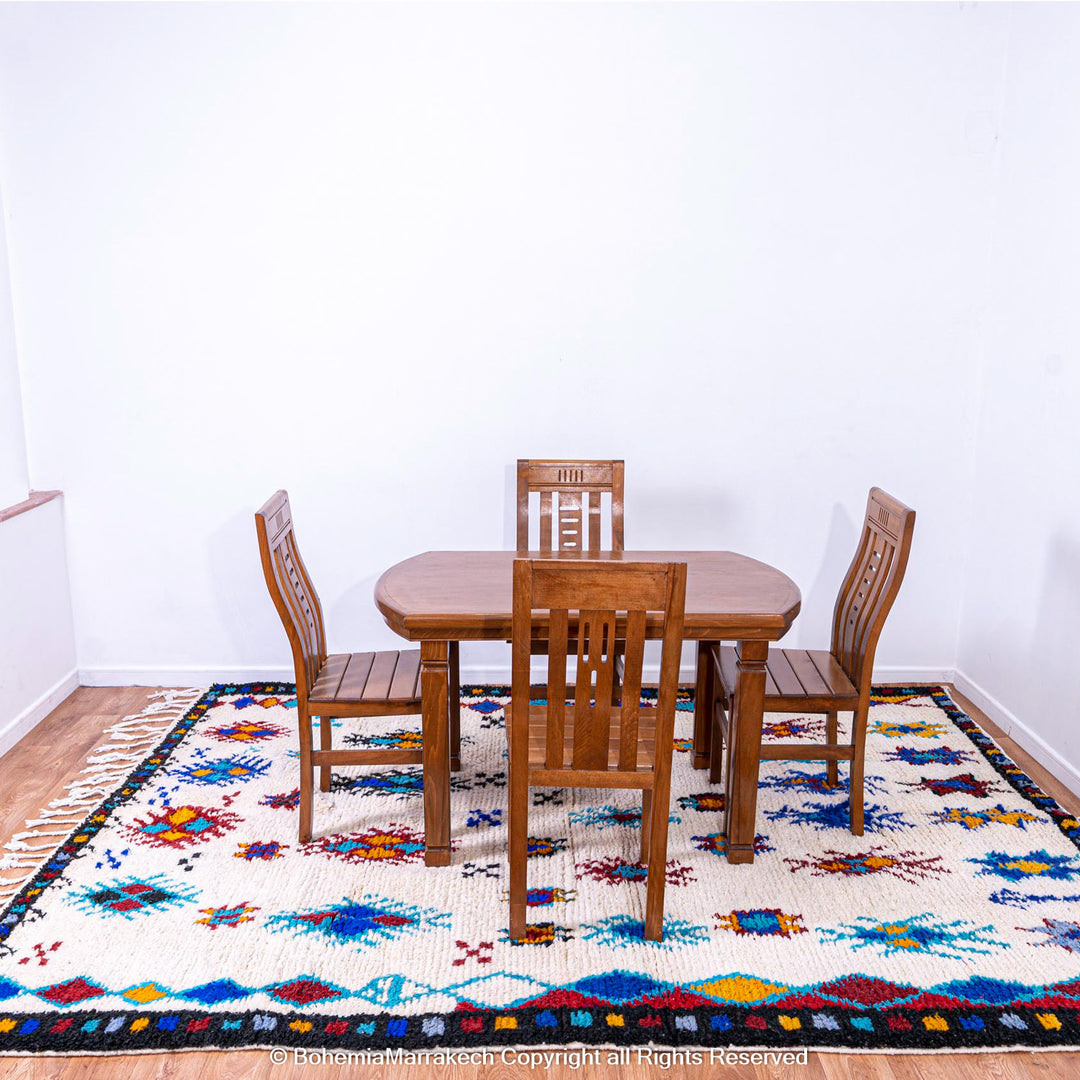 White Moroccan wool rug with colorful Berber tribal motifs and dark border – Beni Ourain handmade