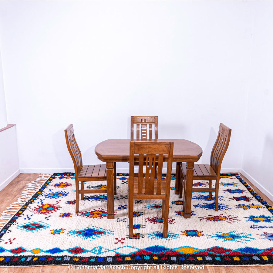 White Moroccan wool rug with colorful Berber tribal motifs and dark border – Beni Ourain handmade