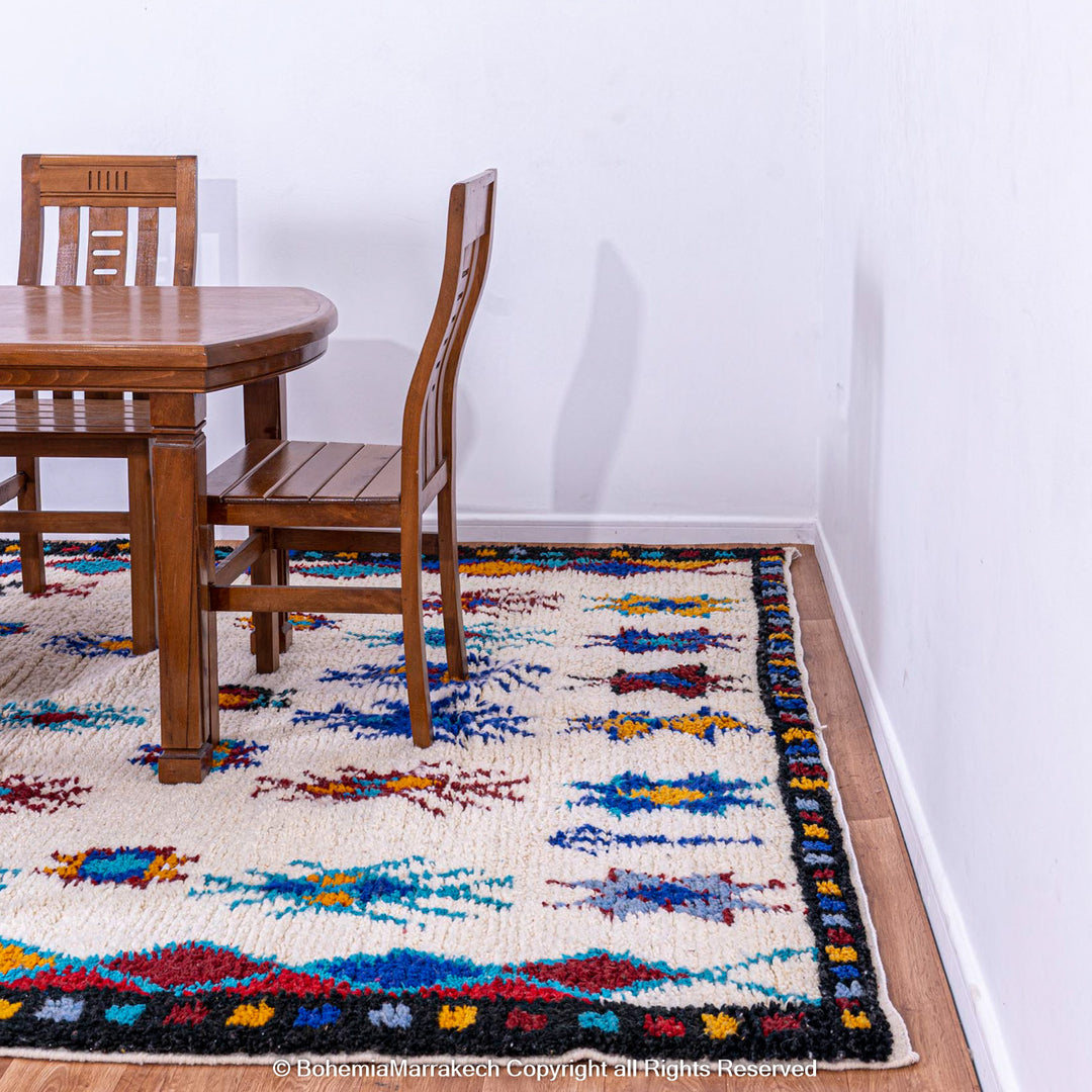 White Moroccan wool rug with colorful Berber tribal motifs and dark border – Beni Ourain handmade