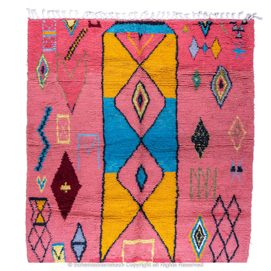 Colorful bright pink Moroccan wool rug with blue and yellow diamond patterns
