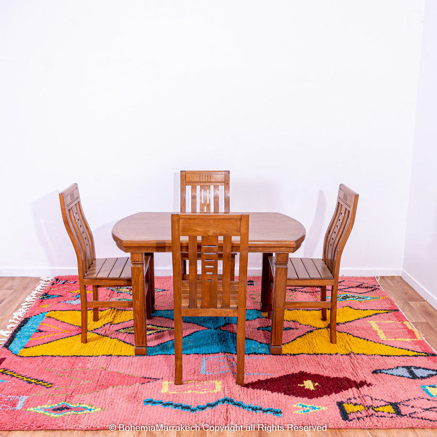 Colorful bright pink Moroccan wool rug with blue and yellow diamond patterns