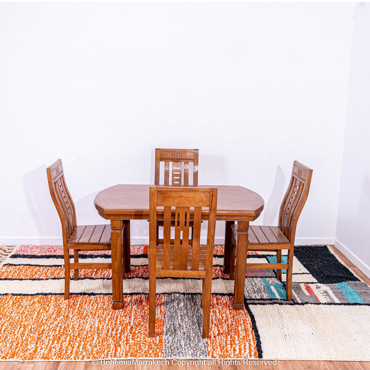Colorful Moroccan rug with orange base and geometric wool patterns in black, cream, turquoise, and pink