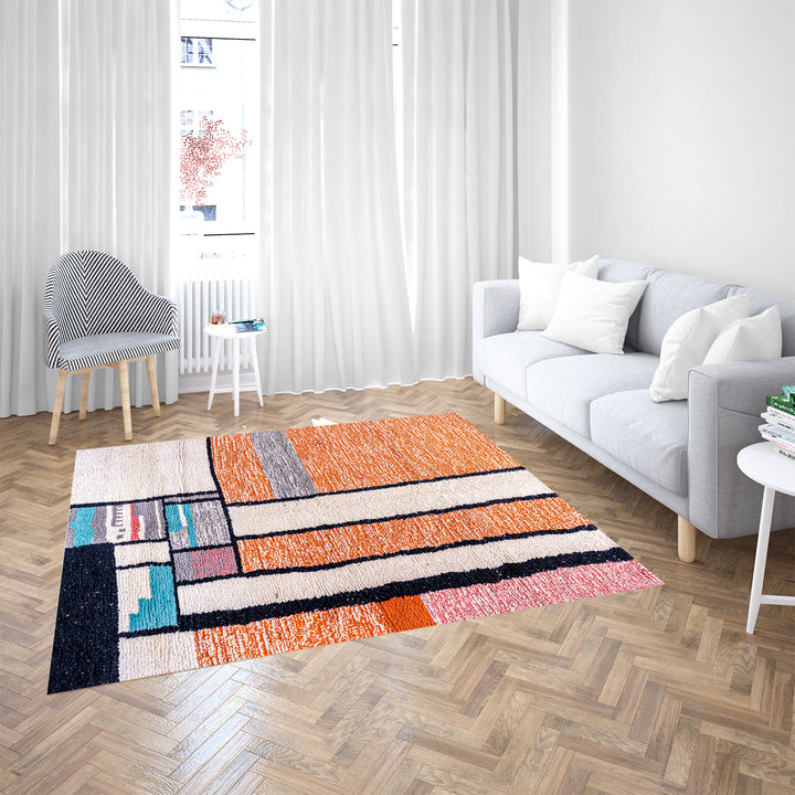 Colorful Moroccan rug with orange base and geometric wool patterns in black, cream, turquoise, and pink