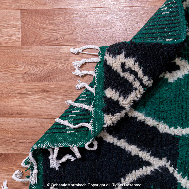 Green Moroccan rug with white tribal diamond lines and navy border, handmade in Beni Ourain wool style