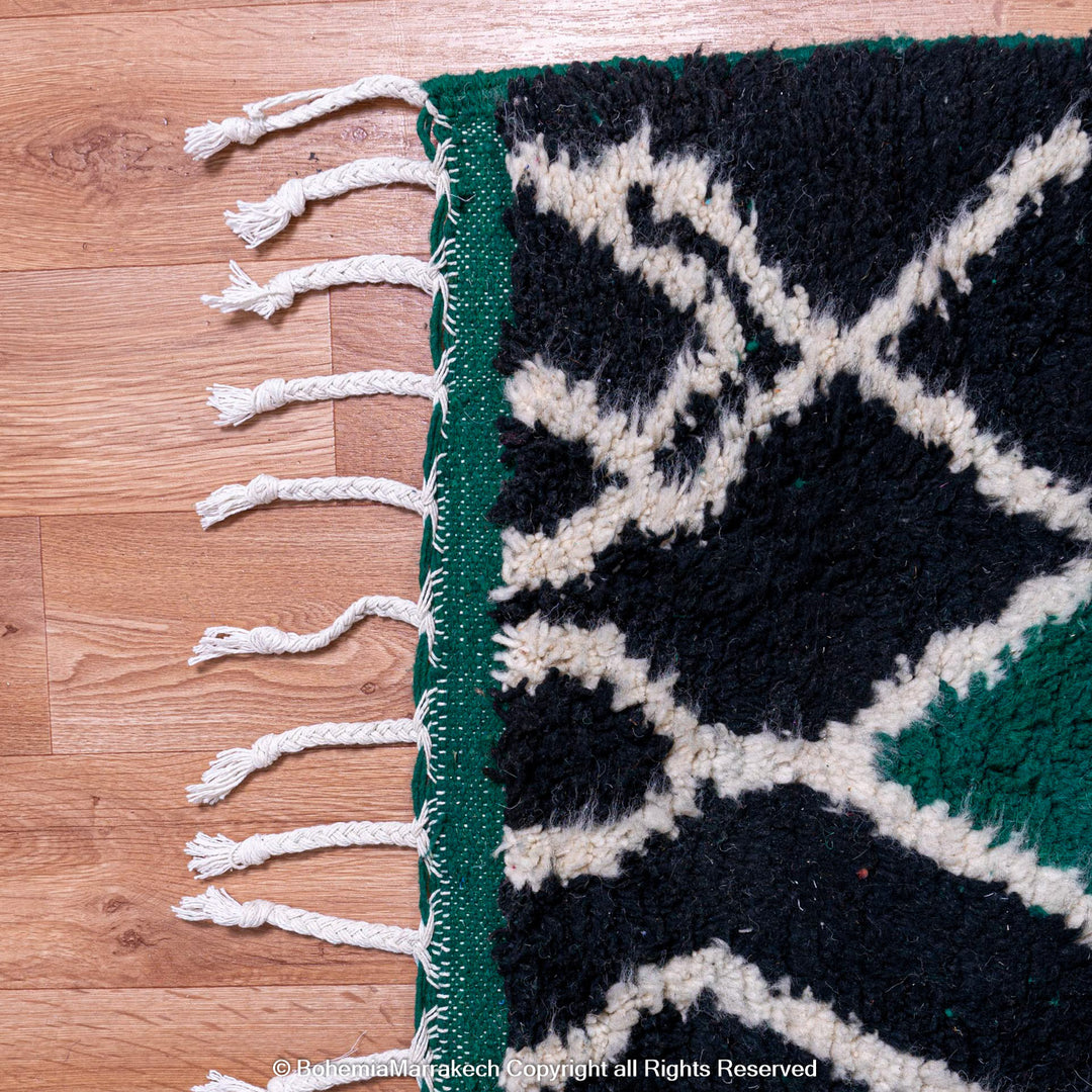 Green Moroccan rug with white tribal diamond lines and navy border, handmade in Beni Ourain wool style