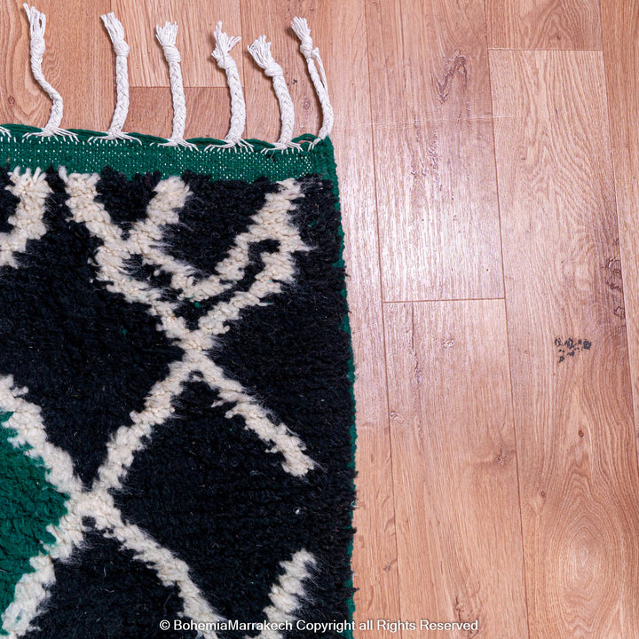 Green Moroccan rug with white tribal diamond lines and navy border, handmade in Beni Ourain wool style