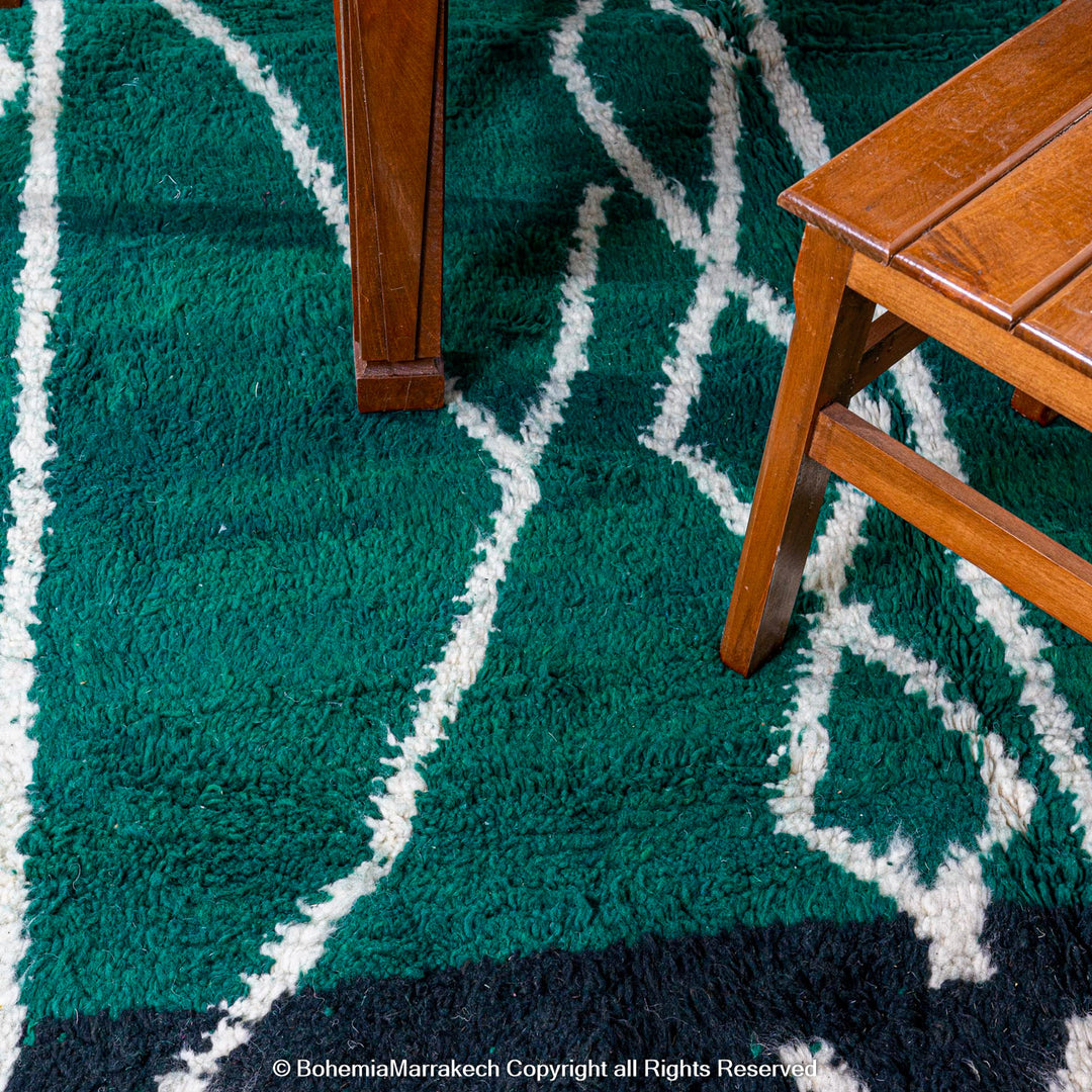 Green Moroccan rug with white tribal diamond lines and navy border, handmade in Beni Ourain wool style