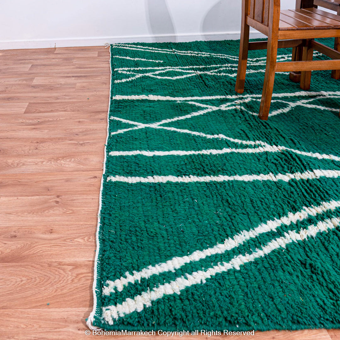 Green Moroccan rug with white tribal diamond lines and navy border, handmade in Beni Ourain wool style