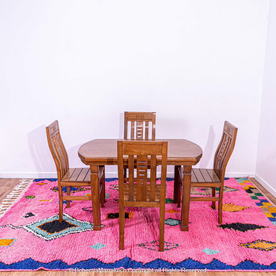 Handmade pink Moroccan rug with colorful geometric Berber motifs