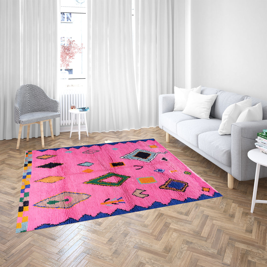 Handmade pink Moroccan rug with colorful geometric Berber motifs