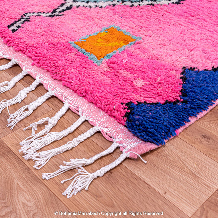 Handmade pink Moroccan rug with colorful geometric Berber motifs