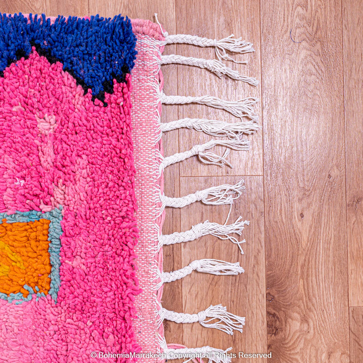 Handmade pink Moroccan rug with colorful geometric Berber motifs