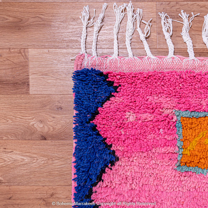 Handmade pink Moroccan rug with colorful geometric Berber motifs