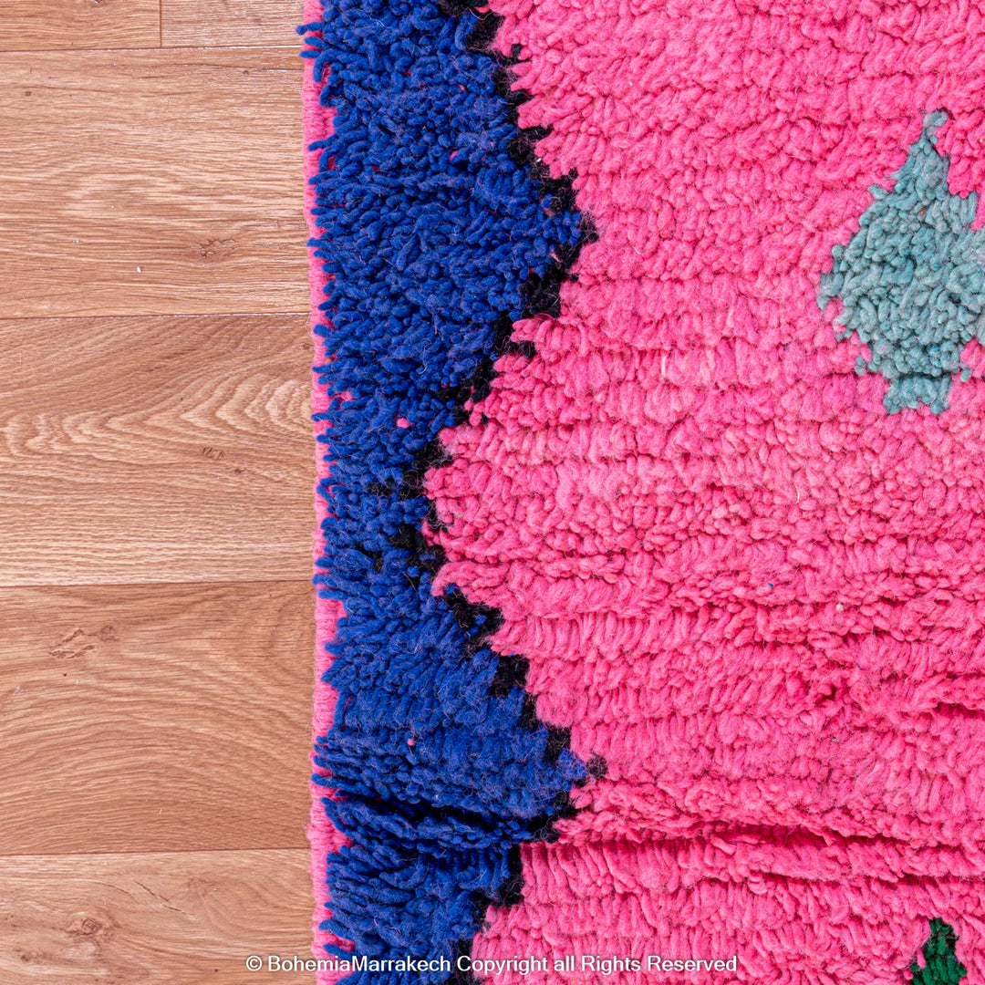 Handmade pink Moroccan rug with colorful geometric Berber motifs