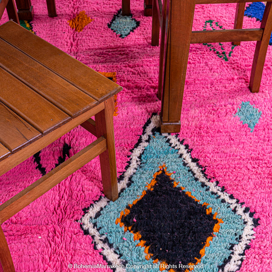 Handmade pink Moroccan rug with colorful geometric Berber motifs