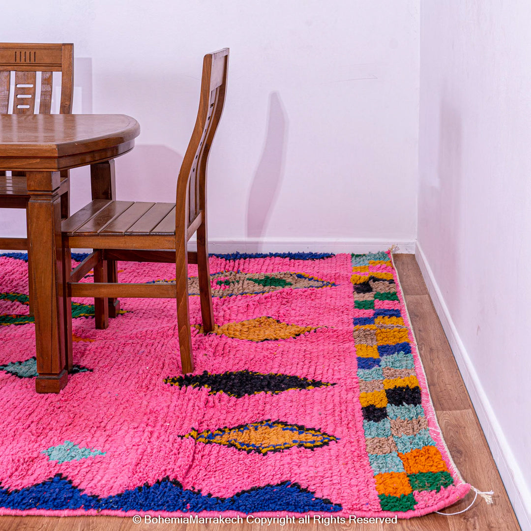 Handmade pink Moroccan rug with colorful geometric Berber motifs