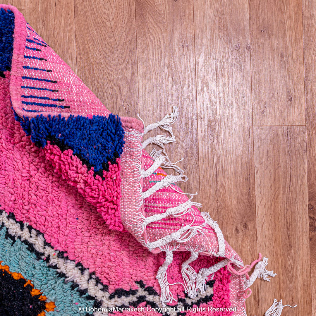 Handmade pink Moroccan rug with colorful geometric Berber motifs