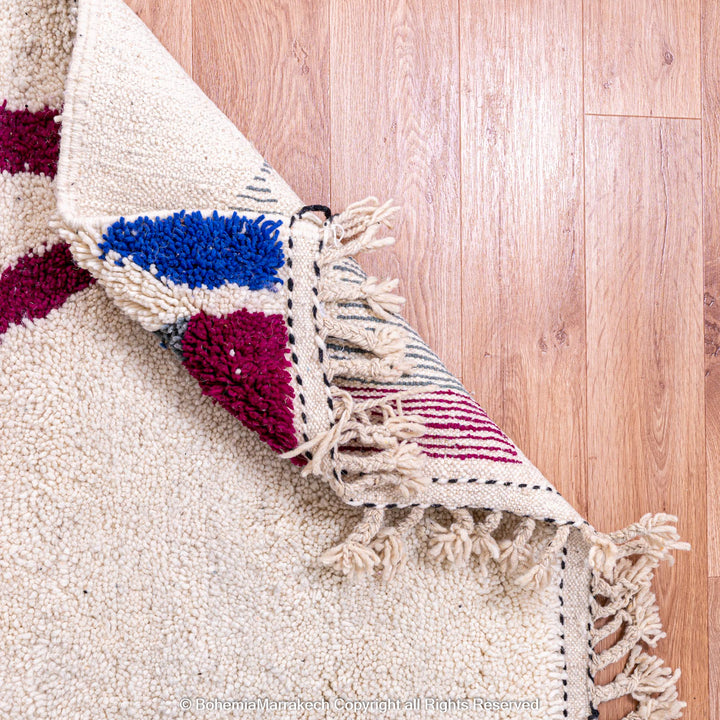 Handmade multicolored Moroccan wool rug with abstract geometric design