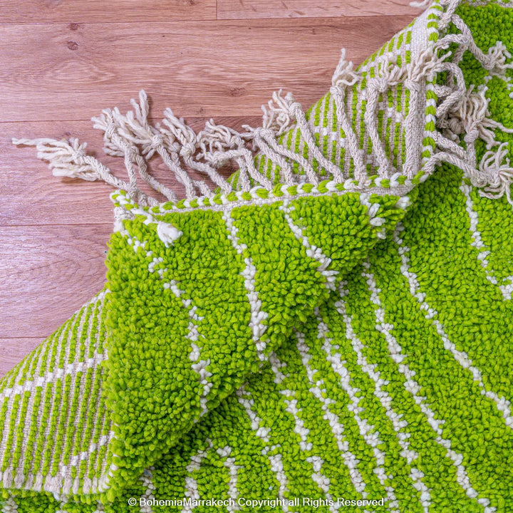 Green Moroccan wool rug with organic line patterns, handmade by Berber artisans