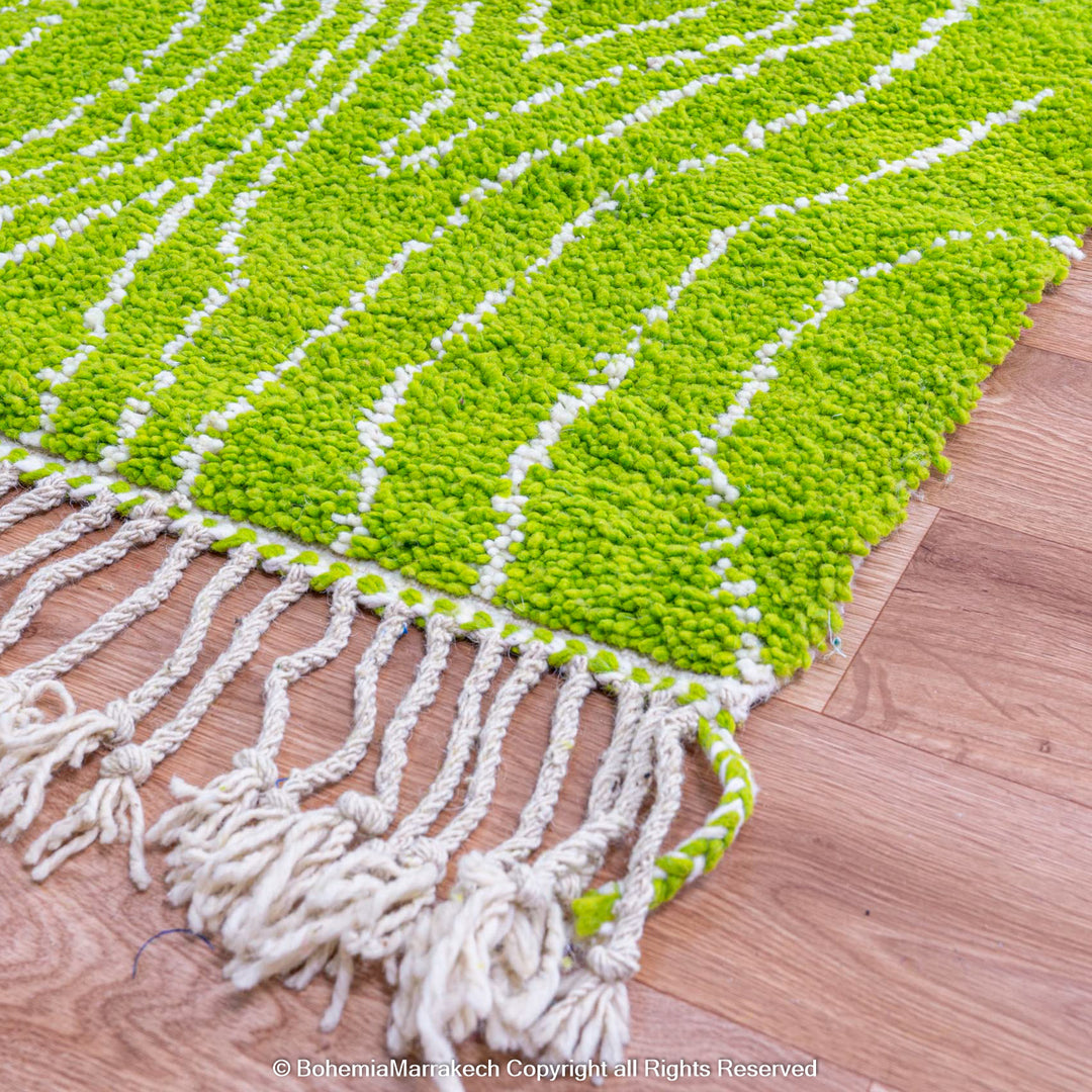 Green Moroccan wool rug with organic line patterns, handmade by Berber artisans
